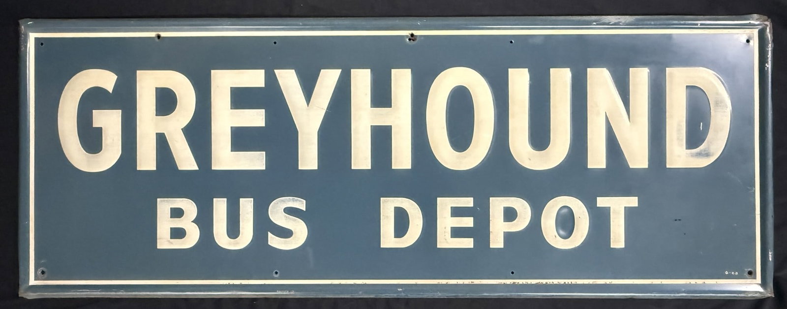 Greyhound Bus Depot Self Framed Tin Embossed Station Sign: Marked G-68 bottom right and measures 47.5" x 17.5" - see all photos