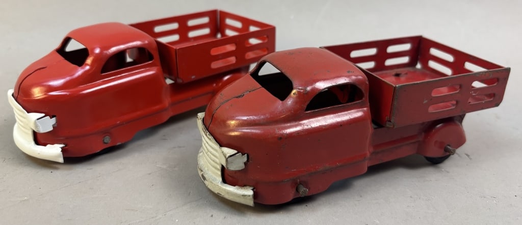 Pair of Wyandotte Pressed Steel Stake Bed Trucks: One truck has original paint, the other has been repainted with modern red and white paint. Please make sure you view all photos and ask any questions you may have! Great original collectible item. Th