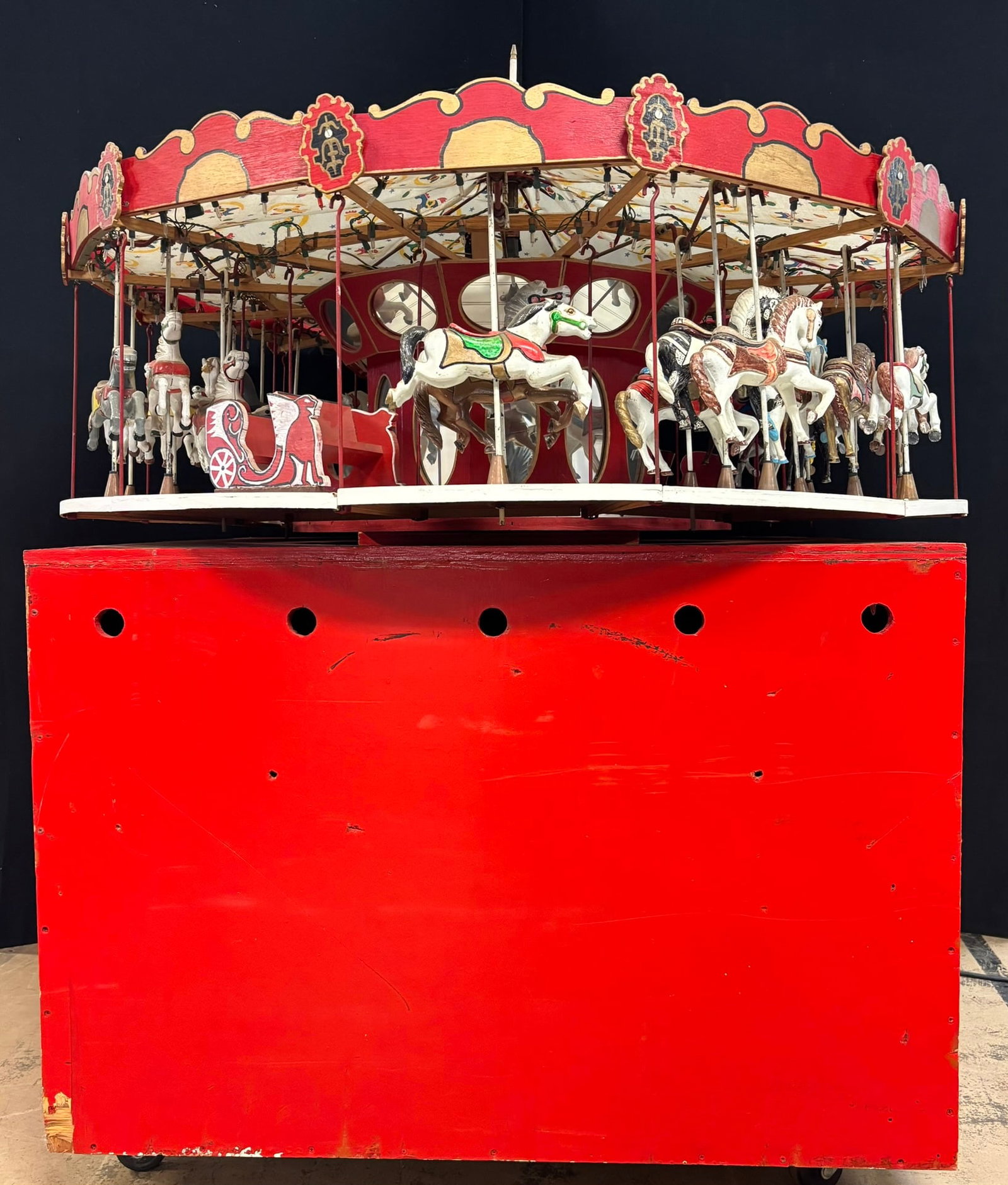 60s 55" Mechanical Horse Carousel Merry Go Round Toy: 55" wide at the top - red base is 46" x 47" x 34" tall - overall it measures 58" tall - horses are made of cast iron. Such an incredible folk art item.