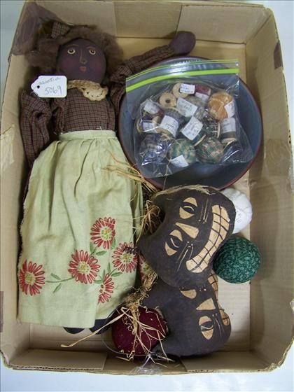 Black stuffed doll with assorted items: Black stuffed doll with assorted rag cloth and balls and spools in bowl