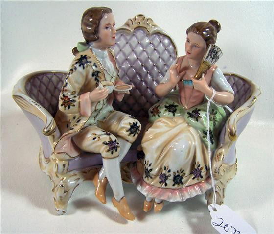 Pair figurine sitting on couch: Pair figurine sitting on couch - #6259 - porcelain with fan and tea cup - 6" by 8"