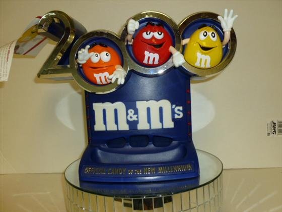M & M Official New Millennium dispenser: M & M candy- Official New Millennium candy dispenser--10 1/2 by 12- pull arm down for candy and lights light