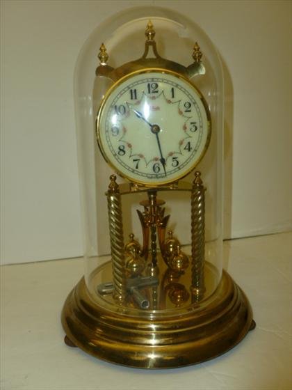 Dome anniversary clock: Dome anniversary clock - wind up - Kundo - with key - plastic dome gold tone base flowers on face - as is0