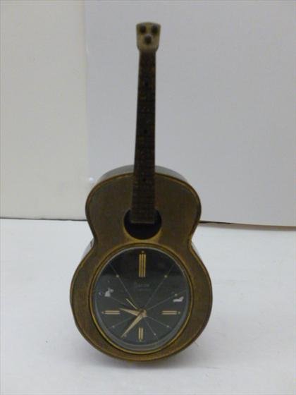 Swiza Swiss 7 jewel wind up alarm clock: Swiza Swiss 7 jewel wind up alarm clock in guitar shape black dial 7 tall metal - wound tight as is