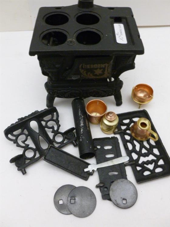 Cast iron toy stove Crescent: Cast iron toy stove Crescent - with all the parts and pots and pans in brass and copper 5 1/2 by 4 by 4 1/2 - great shape