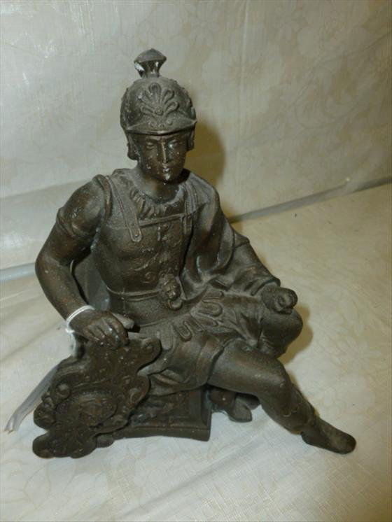 Pot metal clock top Roman soldier: Pot metal clock top Roman soldier sitting on bench- ready for mounting -7 by 8 1/2