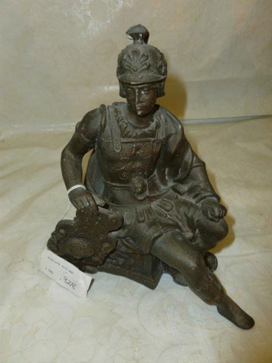 Pot metal clock top Roman soldier: Pot metal clock top Roman soldier sitting on bench- ready for mounting -7 by 8 1/2