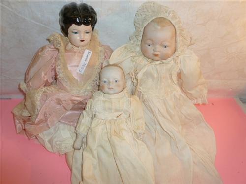 3 porcelain and bisques baby dolls with cloth bodies: 3 porcelain and bisques baby dolls with cloth bodies- porcelain feet and hands long dresses painted faces- all different and sizes