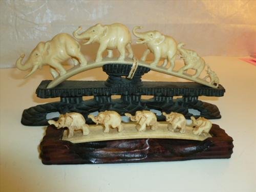 2 pcs- hand carved Ivory Bone??- parade of elephants: 2 pcs- hand carved Ivory Bone??- parade of elephants on rosewood and ebony wood bases-5 graduated sizes 5 1/2-7 1/2" long bases nicely done