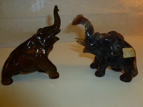 2 hand carved one piece stone or marble elephants: 2 hand carved one piece stone or marble elephants in purple and brown gold colors 4" with trunks up