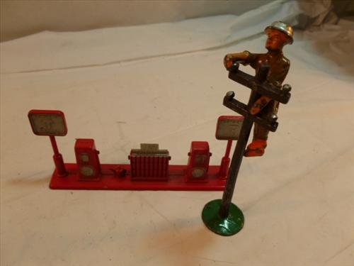 3 piece lead telegraph pole, Tootsie gas pumps &: 3 piece lead Manoil USA telegraph pole with climer-4 1/2" and Tootsie toy gas pumps and island- try Tootsie lube- 5 1/2 by2 1/4"