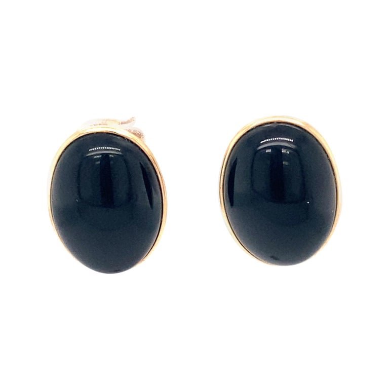 1950s Onyx Stud Earrings in 14 Karat Yellow Gold: Item Details:Gemstone: OnyxMetal: 14 Karat Yellow GoldWeight: 2.4 gramsHallmark: 14KDimensions: 15 millimeters x 11 millimetersOnyx Details:Cut: Cabochon OvalColor: BlackItem Features:These beautiful