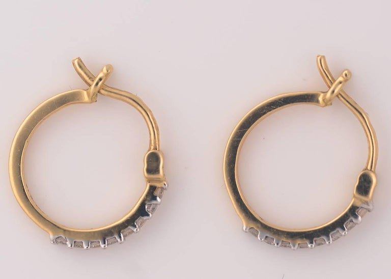 Diamond and 18 Karat Yellow Gold Mini Hoop Earrings: 2017 Mini Hoop Earrings - 18 Karat Yellow Gold, DiamondsMade in House!These Dainty Diamond Hoops feature .13 carats of Round Brilliant Diamonds prong set in rich 18 Karat Yellow Gold. The Diamonds Spa