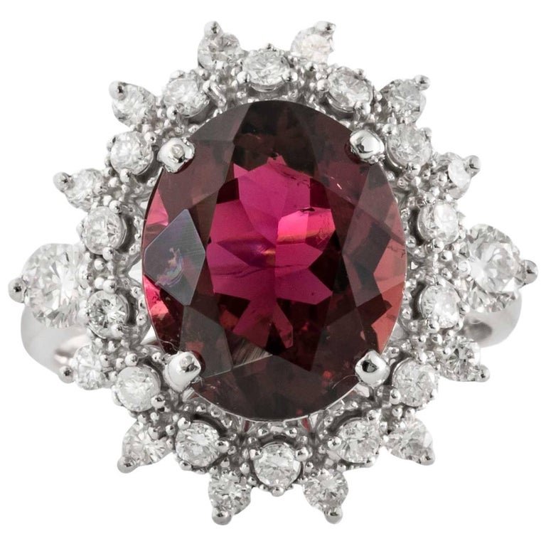 4 Carat Tourmaline, Diamond and 14K White Gold Ring: 1990s Tourmaline and Diamond Cocktail RingCenter is a Gorgeous 4 Carat TourmalineOval Brilliant Cut, Natural, Red Tourmaline Prong-SetBeautifully crafted floral halo of accent diamonds give this ring 