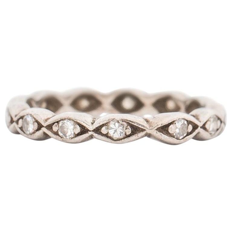1940s .20 Carat Diamond Band in 14 Karat Diamond Gold: Metal type: 14 Karat White GoldWeight: 2.8 gramsFits ring size 4.25, not resizable Diamond Details:Cut: Round BrilliantCarat: .20 Carat Total Weight Accent Diamonds The ring band is from 1940s. The de