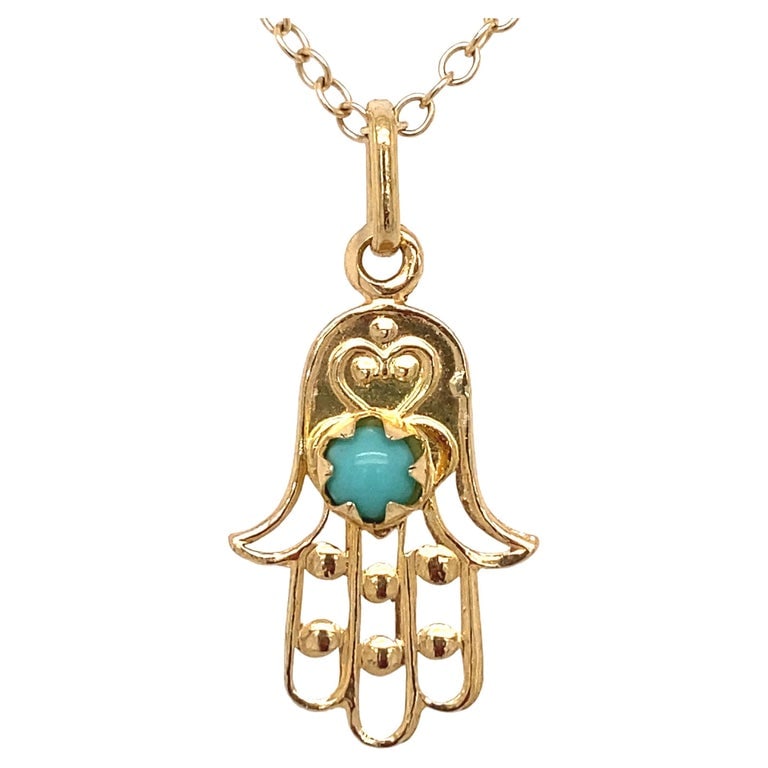 Circa 1950s Turquoise Evil Eye Hamsa Pendant in 18 Karat Gold: Chain not included. Circa: 1950, Metal Type: 18 Karat Yellow Gold, Weight: 1 grams, Dimensions: 1 inch Length (including bail) FD#1965A-ATL/LA265