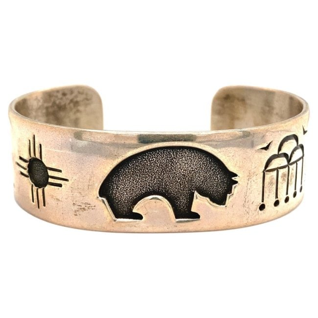 Neal Paquin Native American Bear Motif Cuff in Sterling Silver: Item Details: This cuff bracelet by Native American artisan Neal Paquin features a bear motif. Circa: 1990s Metal Type: Sterling silver Weight: 38.4 grams Size: 0.6 inch Width