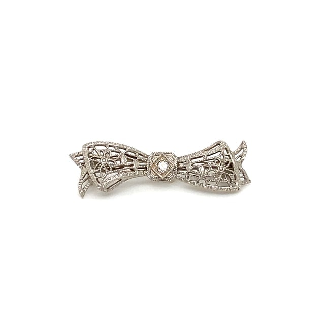 Circa 1940s 14k White Gold Filigree & White Sapphire Bow Pin Brooch: Item Description:Here we have a gorgeous vintage beauty! Belonging to circa 1940s, this intricate bow-shaped pin includes handmade filigree work throughout and a milgrain halo around the white sapphir
