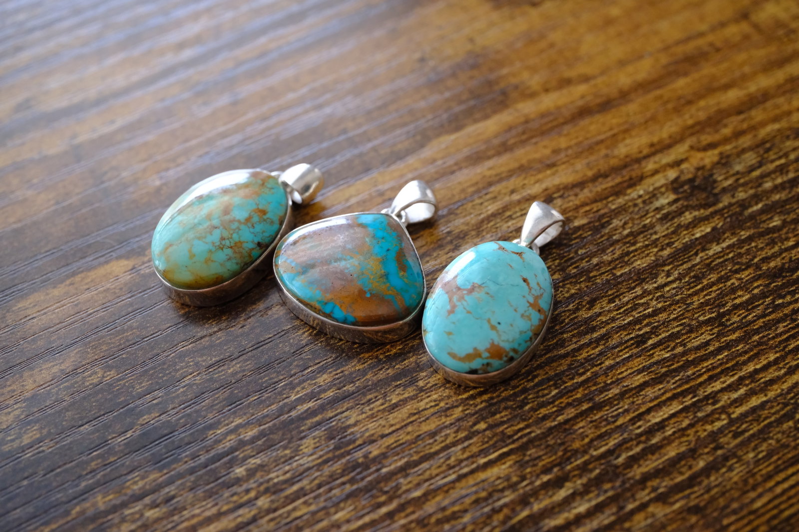 Lot of Three Turquoise Pendants in Sterling Silver: Metal type: Sterling Silver, Stone: Turquoise, Dimensions: 35 mm length, 33 mm length and 31 mm length including bail, total weight: 19.0 g