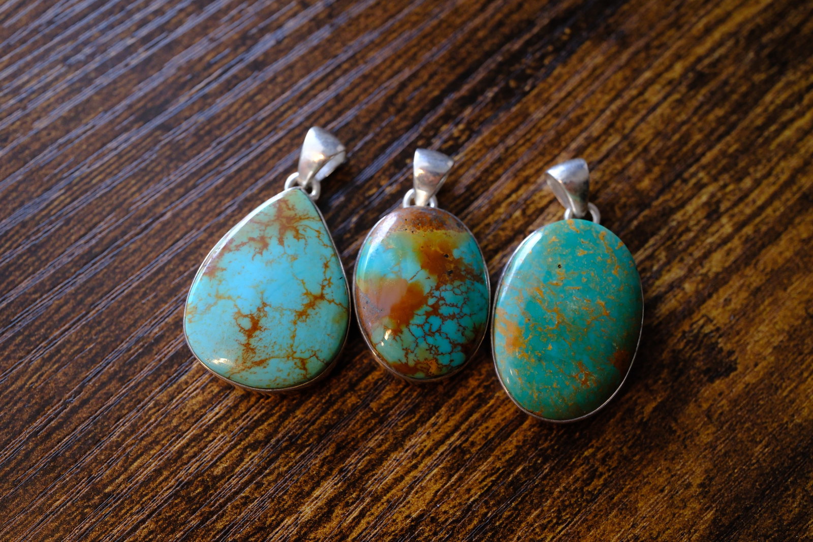 Lot of Three Turquoise Pendants in Sterling Silver: Metal type: Sterling Silver, Stone: Turquoise, Dimensions: 37 mm length, 36 mm length and 33 mm length including bail, total weight: 23.2 g