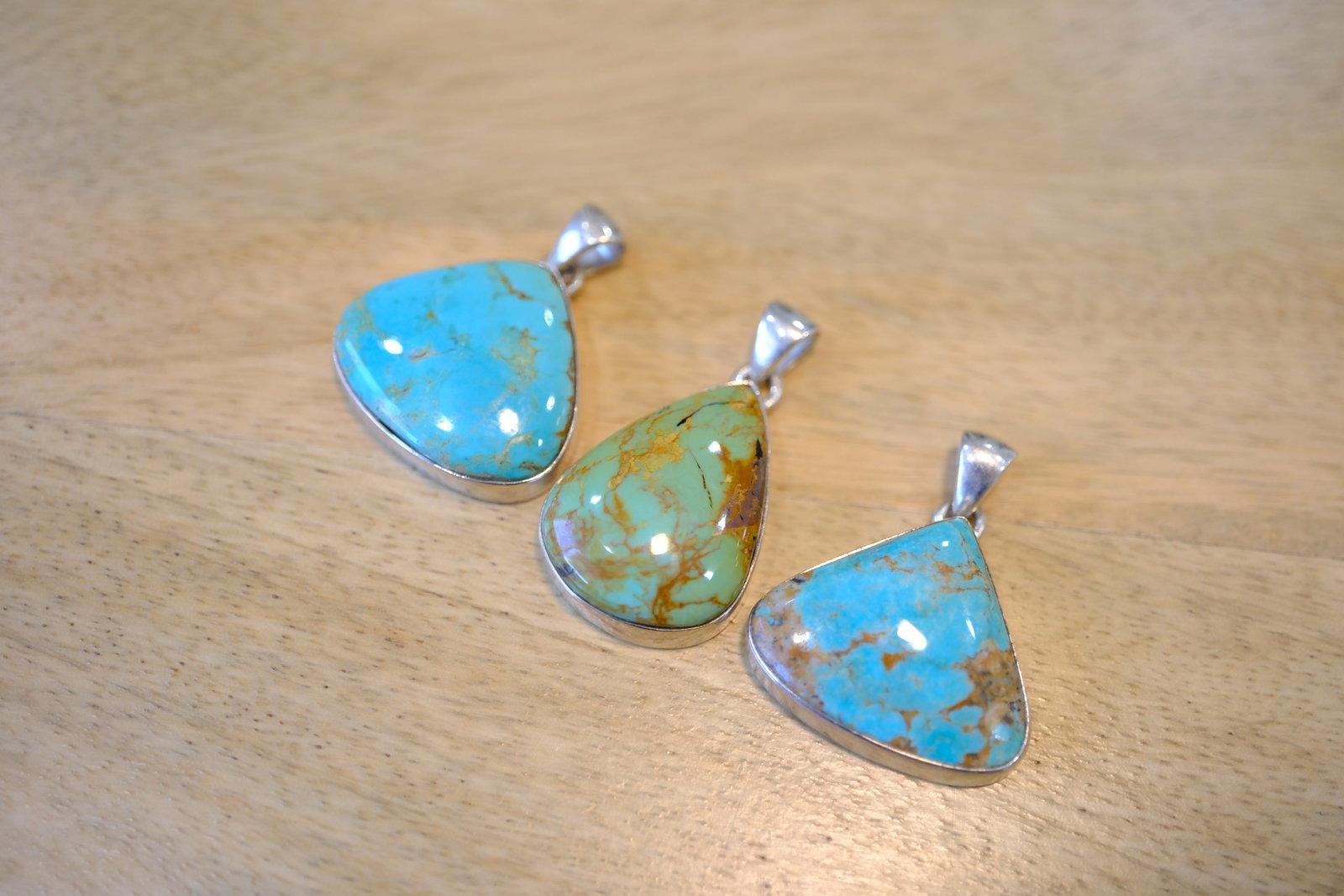 Lot of Three Turquoise Pendants in Sterling Silver: Metal type: Sterling Silver, Stone: Turquoise, Dimensions: 33 mm length, 37 mm length and 33 mm length including bail, total weight: 21.8 g
