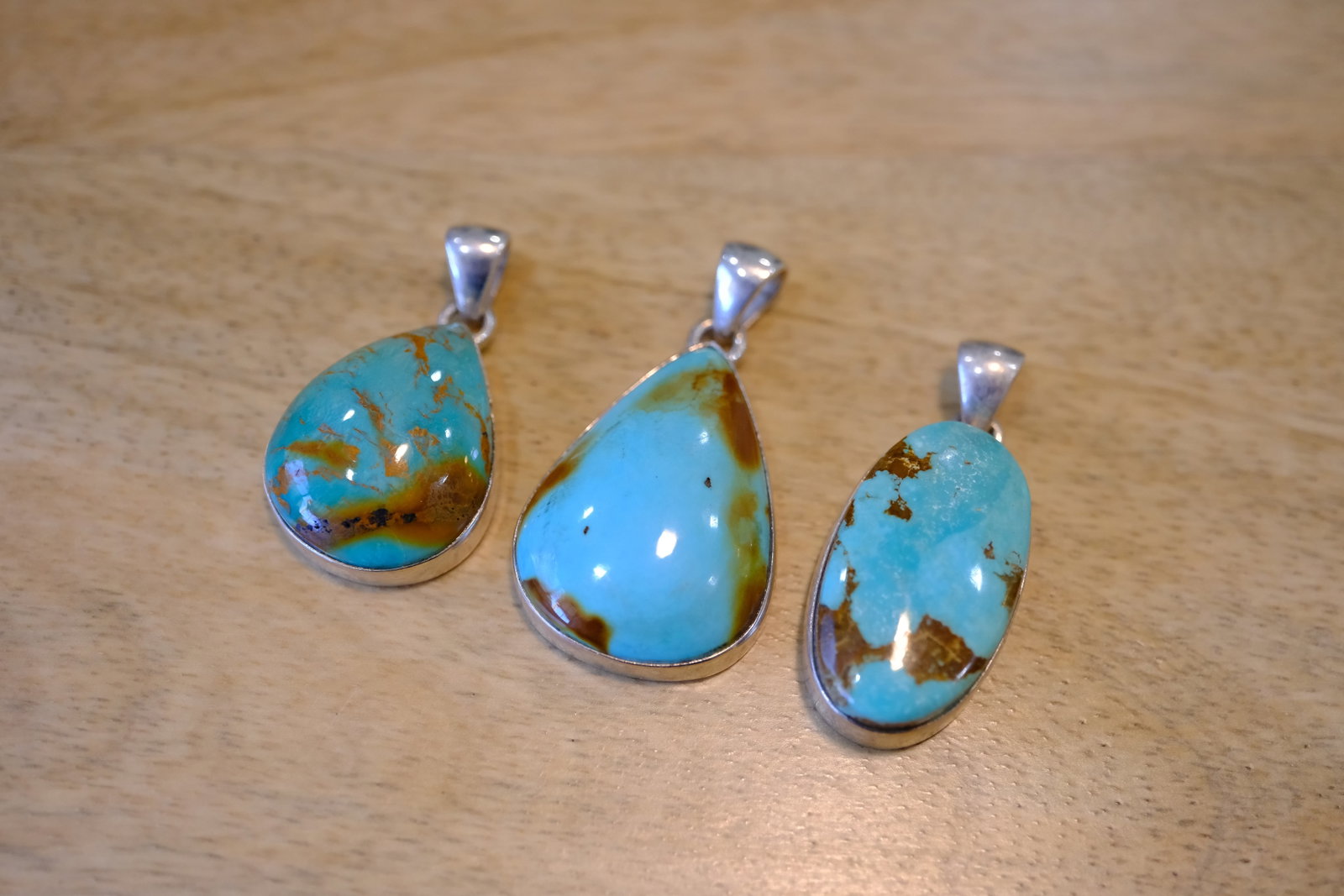 Lot of Three Turquoise Pendants in Sterling Silver: Metal type: Sterling Silver, Stone: Turquoise, Dimensions: 38 mm length, 36 mm length and 32 mm length including bail, total weight: 19.6 g