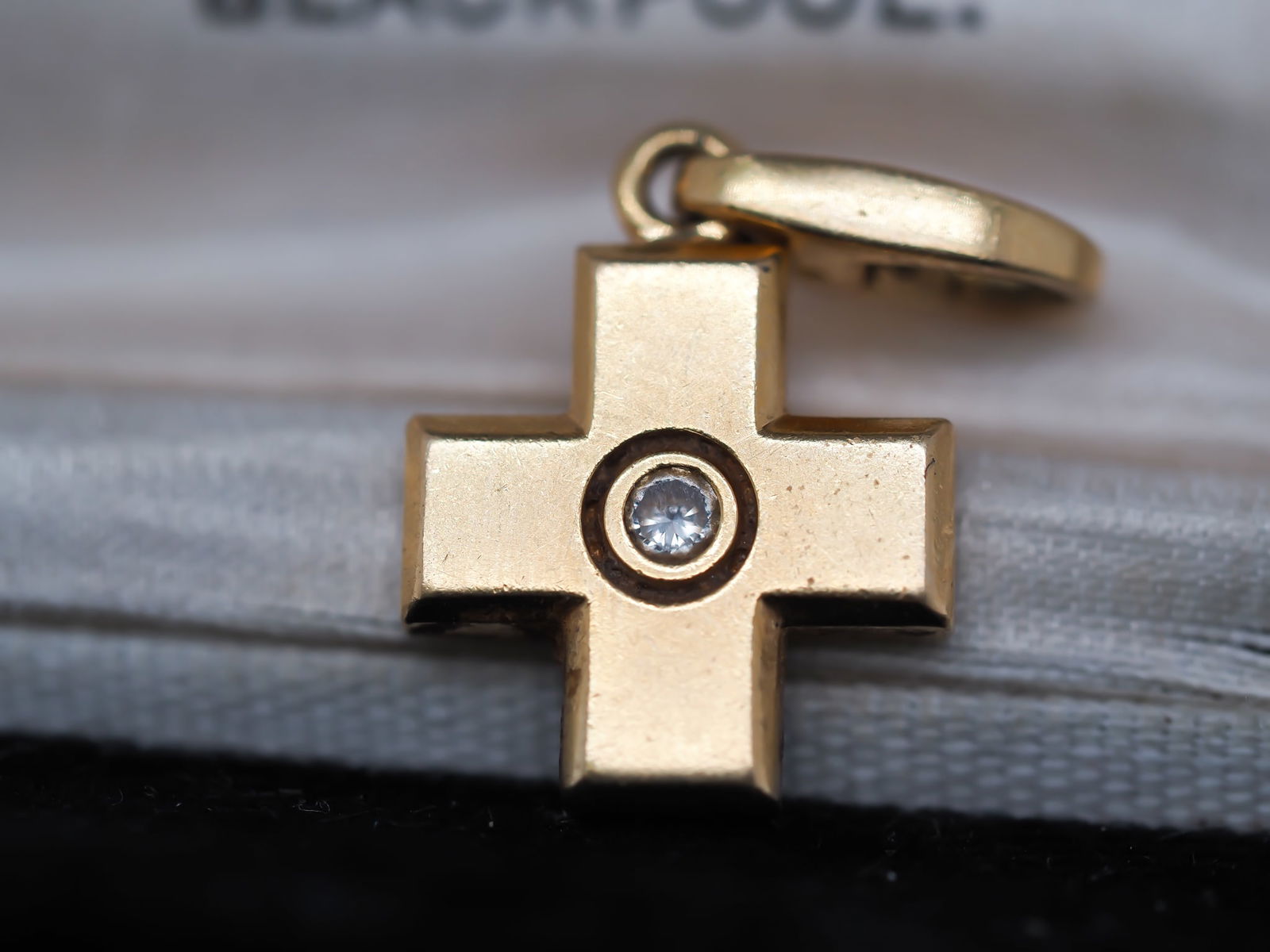 Cartier Cross Pendant with Diamond in 18K Gold: 18K yellow gold (hallmarked and tested) Cartier cross pendant, 4.6 grams. Measures 1"L with bail. Excellent condition. Serial numbers present on back of piece.