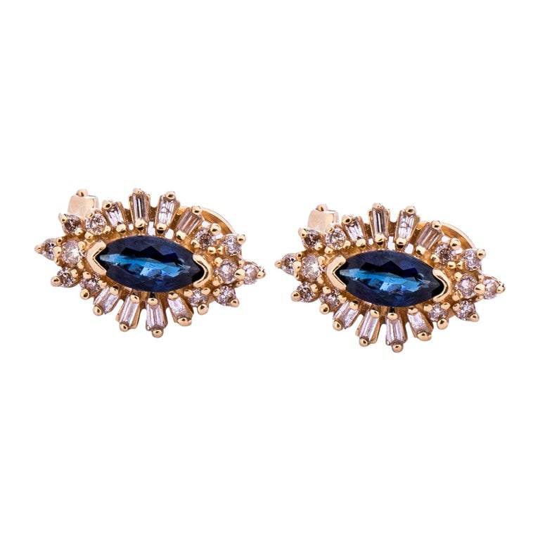 Circa 1970s 1 Carat Sapphire and Diamond Earrings: Retro vintage earrings circa 1970s, in 14 karat yellow gold with royal blue marquise sapphires, approximately 1.0 carat total weight (0.50ct each). Diamond Details: Round and baguette diamonds, H-I co
