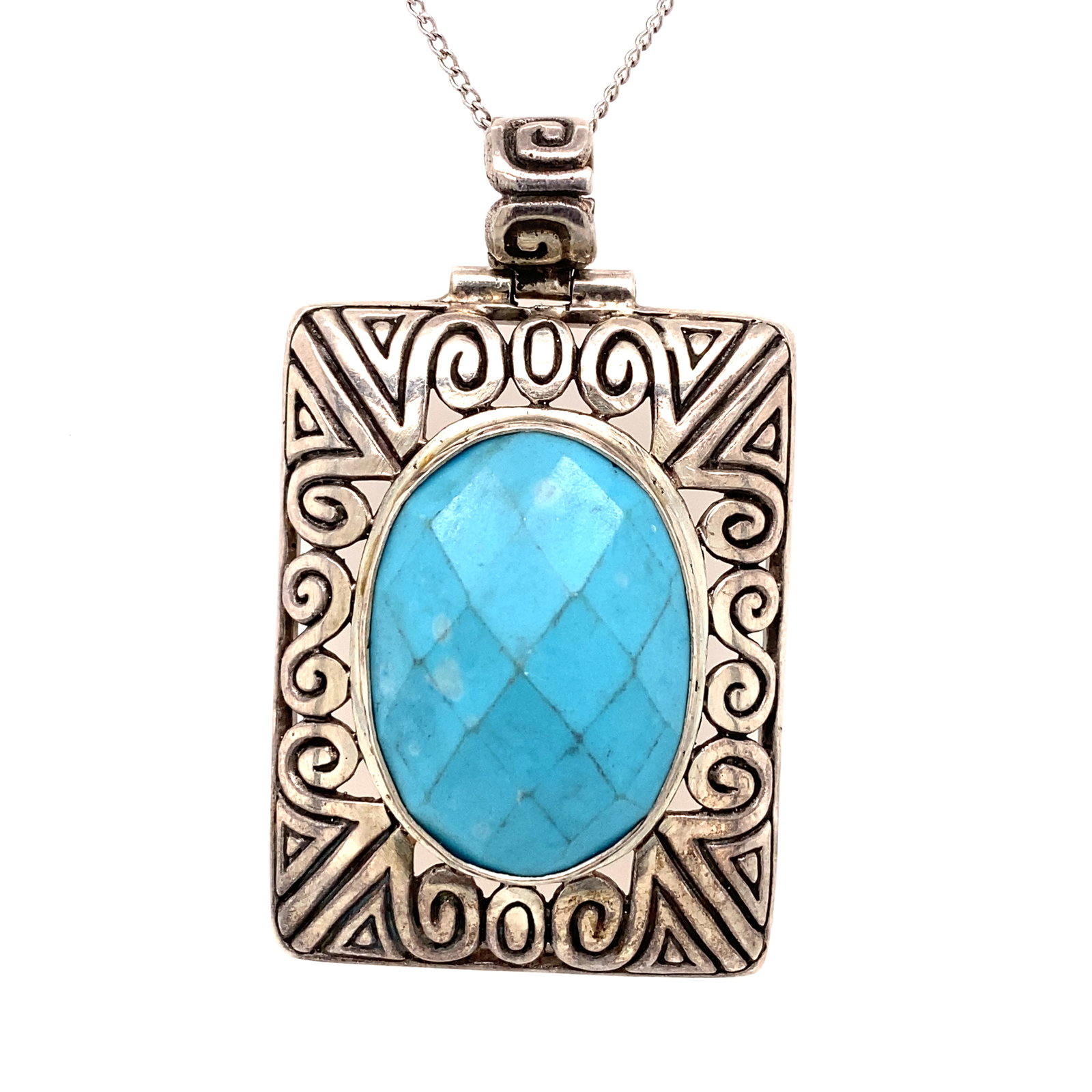 Vintage Turquoise Pendant in Sterling Silver: Era: Vintage: Metal type: Sterling Silver, Design: Scroll, Stone: Turquoise, Dimensions: Approximately 2" length including bail, Weight: 15.3 g. Chain is not included