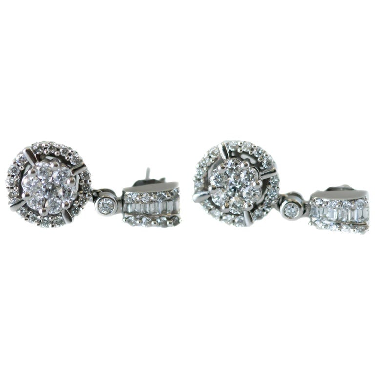 1 Carat Total Diamond Drop Earrings in 14 Karat White Gold: 14 karat white gold earrings with 1.0 carat total weight of round and baguette diamonds, 20x10mm, 4.1 grams.