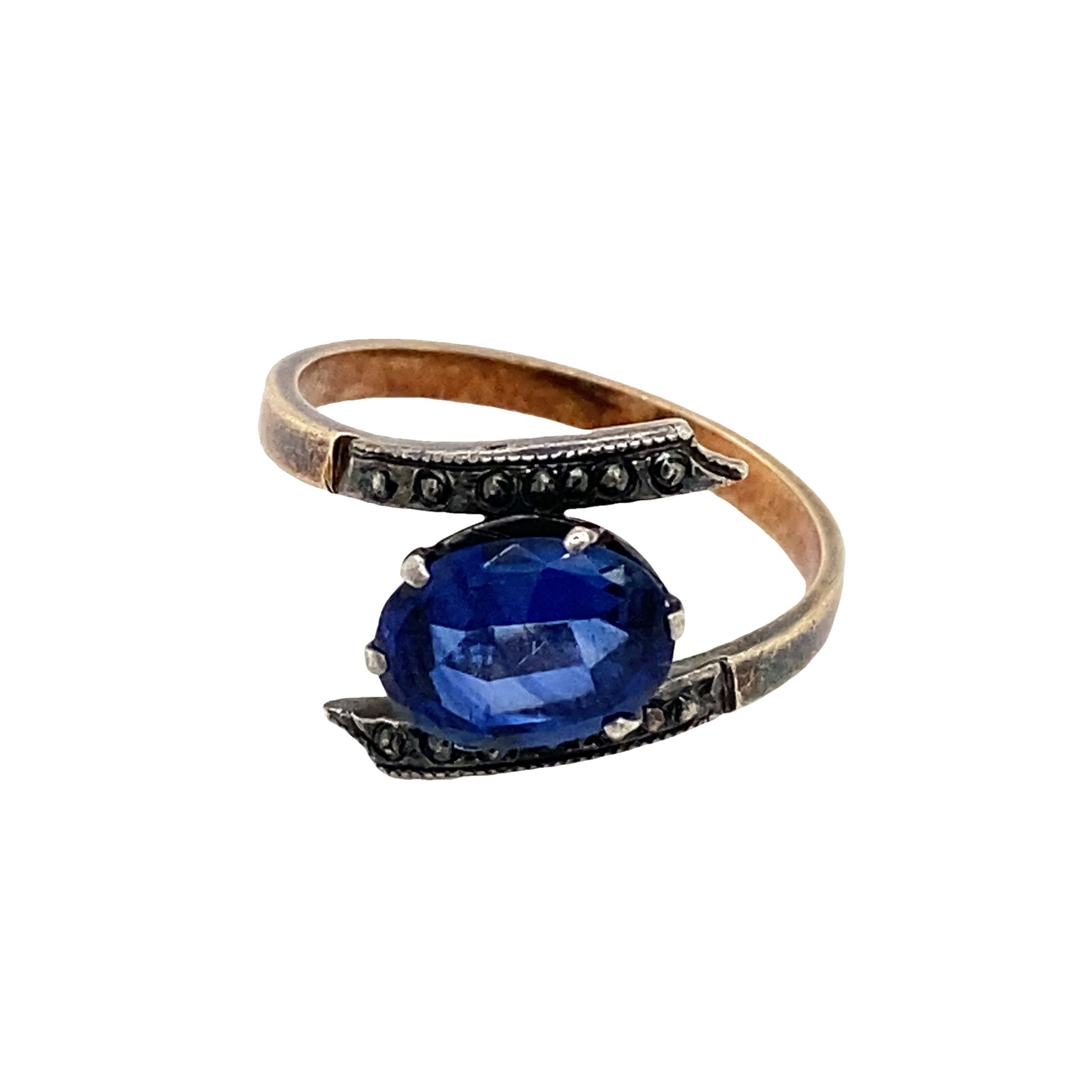 Circa 1910s Edwardian Simulated Sapphire Bypass Ring in 9K Yellow Gold: Circa: 1910, Style: Edwardian, Metal type: 9K Yellow Gold, Gemstone: Simulated Sapphire, Design: Bypass ring, Size: 7, Weight: 3.0 g
