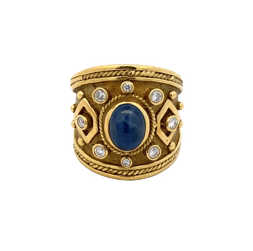 Star Sapphire and Diamond Ring in 18K Yellow Gold: Metal type: 18k yellow gold, Gemstones: Star sapphire and diamond, Sapphire measurement: 0.6 mm L x 0.8 H, Size: 6, Weight: 14.9 grams