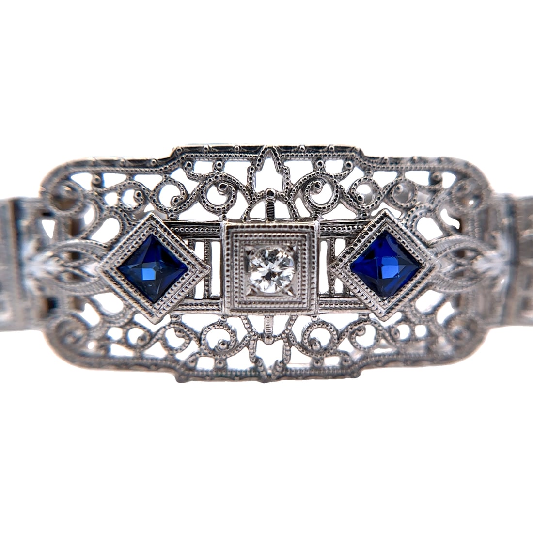 Circa 1920s Art Deco Filigree Bracelet with Diamond and Sapphire in 14K White Gold: Circa: 1920s, Art Deco, Metal type: 14k white gold, Gemstones: .22ctw diamond and sapphire, Design: Filigree bracelet, Measurement: 7" Length, Weight: 15.7 grams