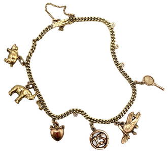 Vintage Multi-Charm Bracelet in 14K Yellow Gold: Vintage, Metal type: 14k yellow gold, Design: Multi-charm bracelet, Measurement: 6.25" Length, Weight: 6.8 grams
