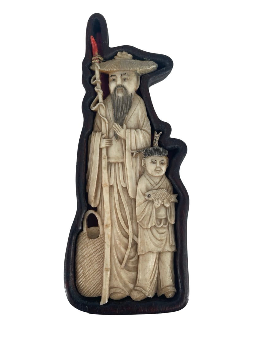 19th Century Meiji Period Japanese Okimono Depicting an Old Man and a Child Holding Fish: Description: 19th century Meiji period Japanese okimono depicting an old man and a child holding fish, in its original wooden case. The okimono is made of bone, and the tip of the staff is made of cor
