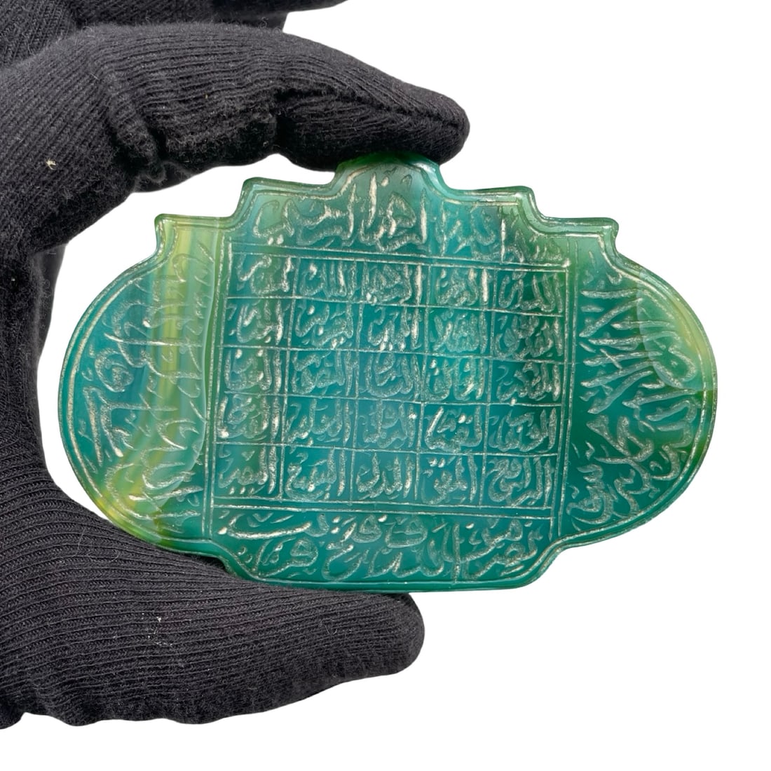 An Intricately Engraved Islamic Green Chalcedony Agate Amulet Plaque, featuring an Elegant: An Intricately Engraved Islamic Green Chalcedony Agate Amulet Plaque, featuring an Elegant Calligraphic Grid and Protective Invocations.This impressive horizontally oriented talismanic plaque is exper