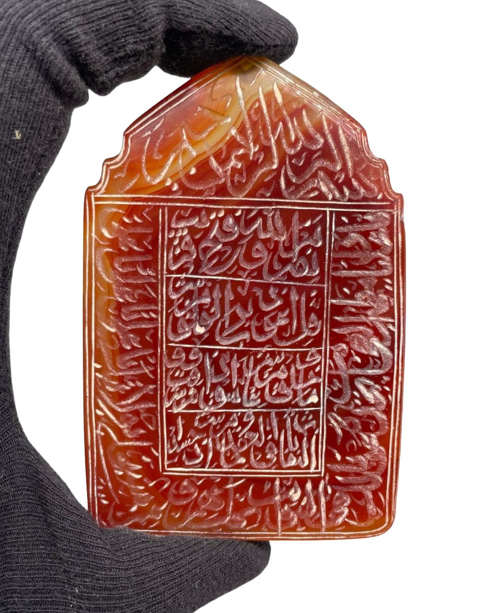 A Striking Hand-Carved Mihrab-Form Islamic Carnelian Agate (Yemeni Aqeeq) Talismanic Plaque, Densely: A Striking Hand-Carved Mihrab-Form Islamic Carnelian Agate (Yemeni Aqeeq) Talismanic Plaque, Densely Engraved with Quranic Script. This magnificent, vertically oriented protective amulet is masterfull