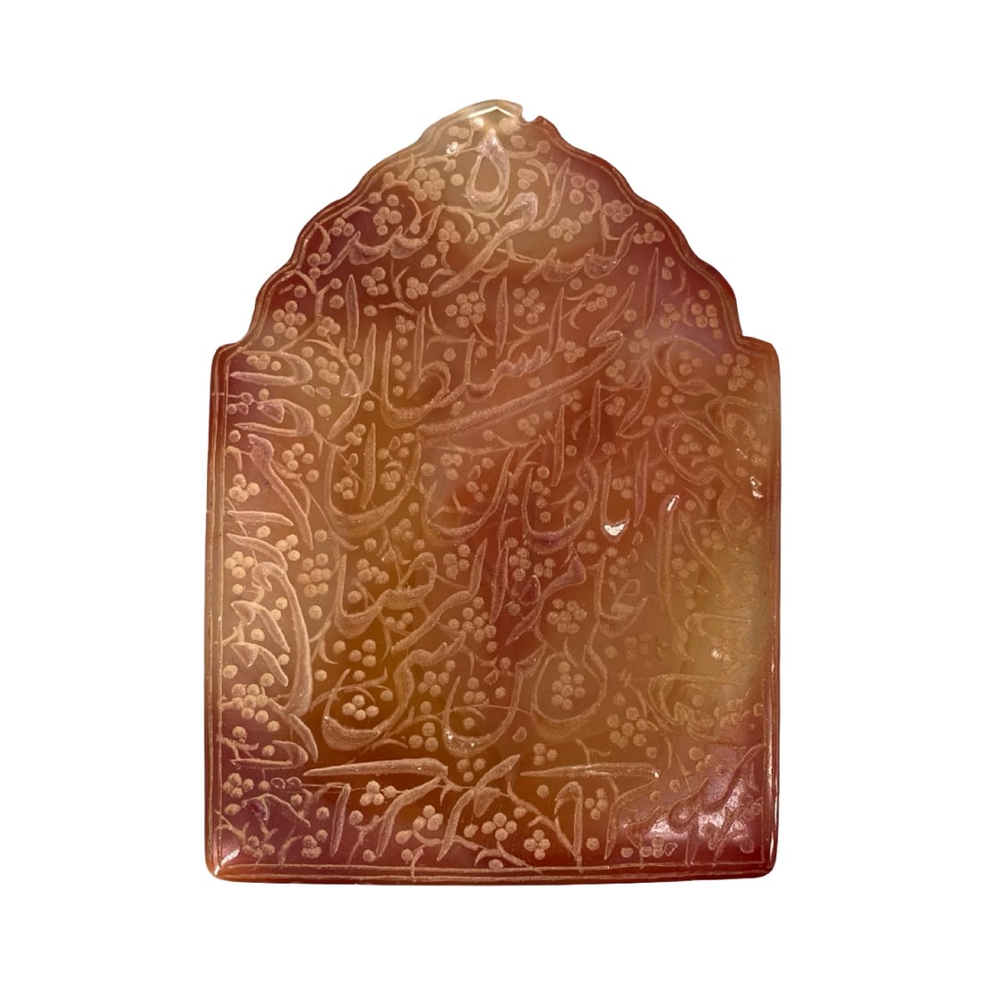 An Exquisite Mihrab-Form Islamic Orange-Honey Agate Talismanic Plaque, Deeply Carved with Elegant: An Exquisite Mihrab-Form Islamic Orange-Honey Agate Talismanic Plaque, Deeply Carved with Elegant Calligraphy Against a Floral Arabesque Background. This magnificent vertically oriented devotional pla