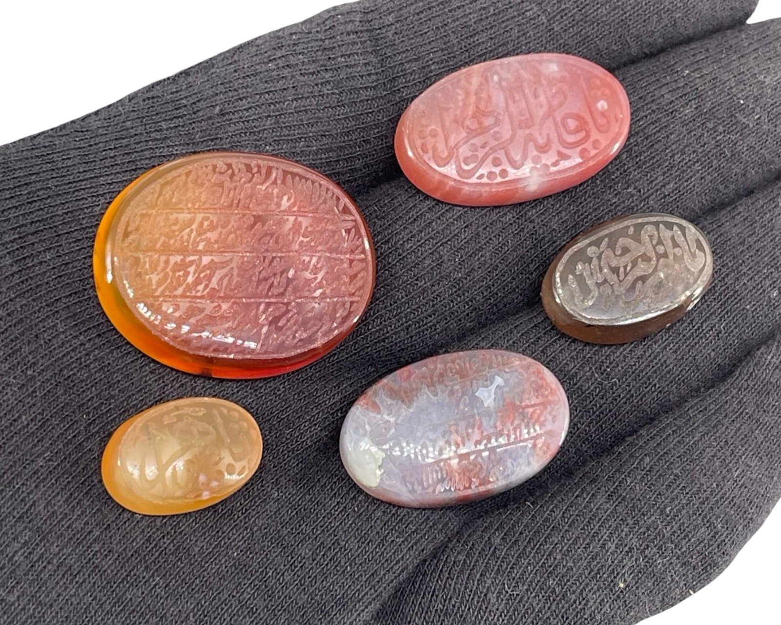 A Collection of Five Islamic Engraved Agate and Carnelian Seal Stones: A Collection of Five Islamic Engraved Agate and Carnelian Seal Stones. This attractive collector’s lot comprises five individual, loose oval cabochon gemstones expertly hand-engraved with traditiona