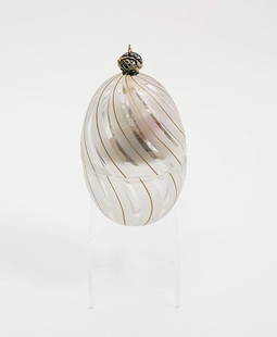 Theo Faberge Coral Egg, 1992: Numbered 513 of 750 Edition, this Decorative Faberge Egg is a colorless and frosted glass egg with a swirl motif and gilt line trim, the top with vermeil crown, and inside the egg is a Sterling