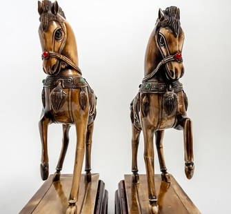 Pair of Two Chinese Horse Figures: A pair of two Chinese horse figures shown with one hoof raised, on molded rectangular base.