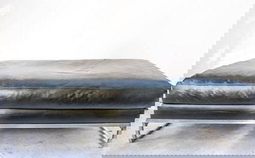 B&B Italia 'Frank' Ottoman by Antonio Citterio: Extra large dark black leather ottoman with polished aluminum legs. 61"W x 61"D x 15"H. There is some scuffing to the leather. The original purchase price from B&B Italia was $4,160. B&B Italia