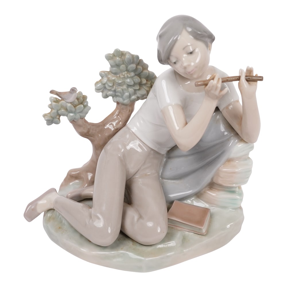 Lladro Student Flute Player Large Porcelain Figurine: Lladro Student Flute Player Large Porcelain Figurine. Lladro porcelain figure depicting a seated boy playing flute with book and dove #4837. Marked to underside. Lladr? is a Spanish brand renowned for