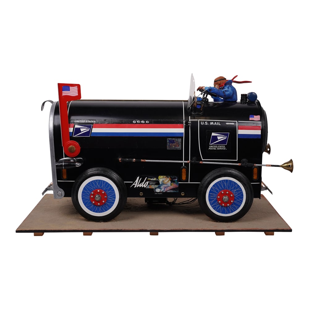 Aldo Amador Custom Contemporary Cuban Art of a U.S. Mailbox: Aldo Amador Custom Contemporary Cuban Art of a U.S. Mailbox Sculpture. Aldo Amador, visible on the model U.S. Mail vehicle, was a Cuban artist who lived from 1940-2008. He is known for his work in