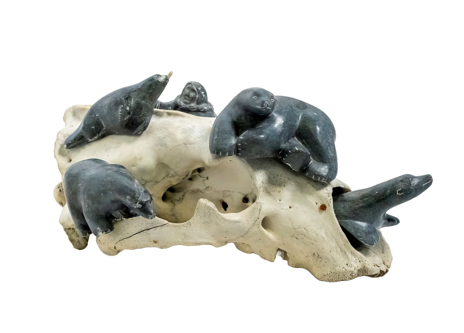 Soapstone Carving of Hunt Scene inside of a Skull Sculpture: Authentic Soapstone Carving of Hunt Scene inside of a Skull Sculpture. Soapstone, also known as steatite, is a metamorphic rock composed primarily of talc, with varying amounts of chlorite, micas,