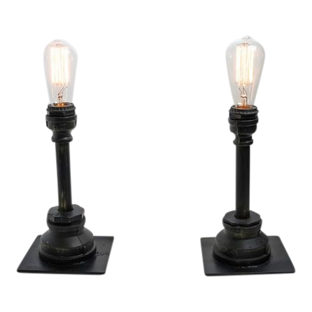Pair (2) Black Cast Iron Lamps with Edison Bulbs: Rustic / Primitive Pair (2) Black Cast Iron Lamps with Edison Bulbs for Desks or Side Tables. Dimensions: Height 15 1/2 in. Provenance: Miami, FL Estate. House of Craven Auction Gallery: Please consid