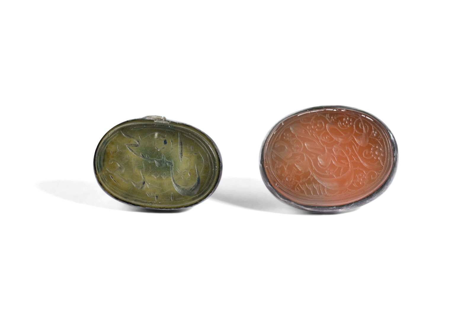 TWO MOUNTED NOMINAL INTAGLIO SEALS WITH MAKERS' NAMES Qajar Iran, dated 1222 AH (1807 AD) and 1300 /: TWO MOUNTED NOMINAL INTAGLIO SEALS WITH MAKERS' NAMESPROPERTY FROM A PRIVATE GLYPTOLOGY COLLECTORQajar Iran, dated 1222 AH (1807 AD) and 1300 / 1313 (?) AH (1883 / 1895 AD) Each of oval shape, table-c