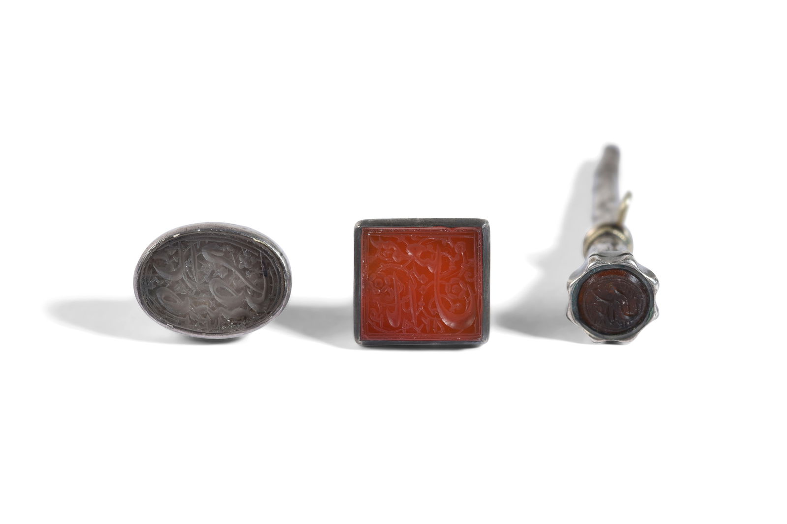 THREE MOUNTED INTAGLIO SEALS WITH SHI'A IMAMS' NAMES Qajar Iran, dated to the second half of the: THREE MOUNTED INTAGLIO SEALS WITH SHI'A IMAMS' NAMESPROPERTY FROM A PRIVATE GLYPTOLOGY COLLECTORQajar Iran, dated to the second half of the 19th century Each of different shape, table-cut, respect