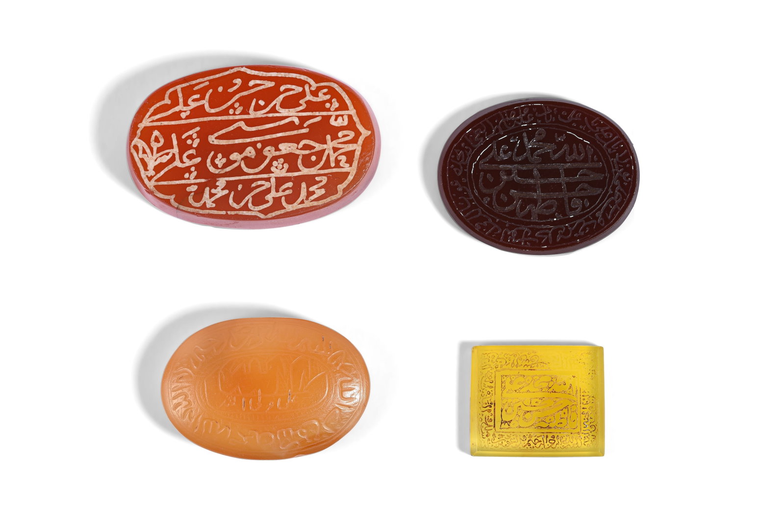 FOUR ENGRAVED AND ETCHED SHI'A HARDSTONE AMULETS Iran and India, second half 19th and early 20th: FOUR ENGRAVED AND ETCHED SHI'A HARDSTONE AMULETS PROPERTY FROM A PRIVATE GLYPTOLOGY COLLECTOR Iran and India, second half 19th and early 20th century Comprising a square and three oval pendants, mostl