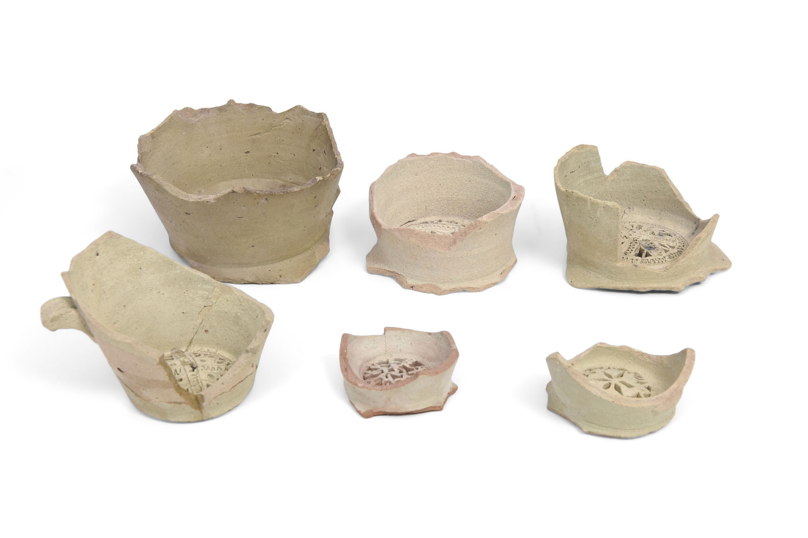 SIX UNGLAZED EARTHENWARE PIERCED WATER JUG FILTERS Fustat, Fatimid Egypt, 10th - 12th century (1 of 9)